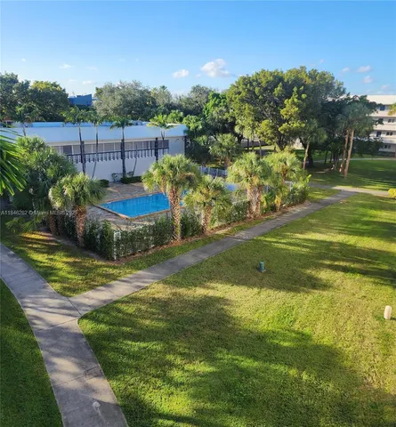 a view of a swimming pool with a yard