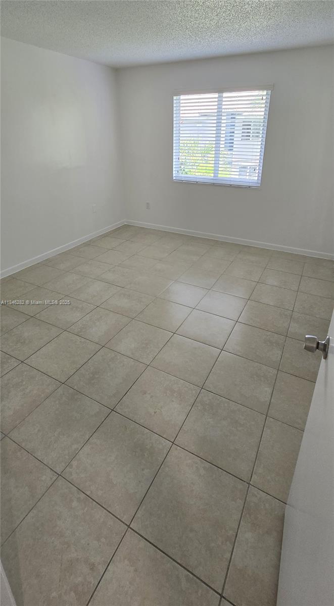 10820 Southwest 200th Drive, Unit 159 Cutler Bay, FL 33157 - Photo 7 of 17 an empty room with windows