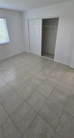 a view of an empty room and a window