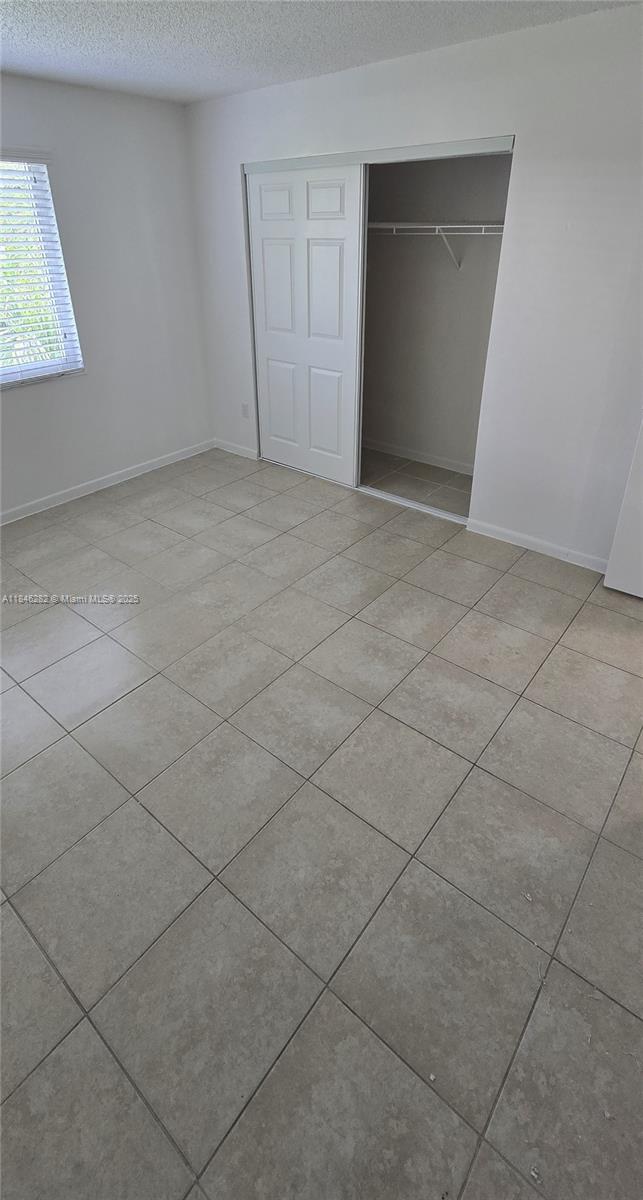 10820 Southwest 200th Drive, Unit 159 Cutler Bay, FL 33157 - Photo 8 of 17 a view of an empty room and a window