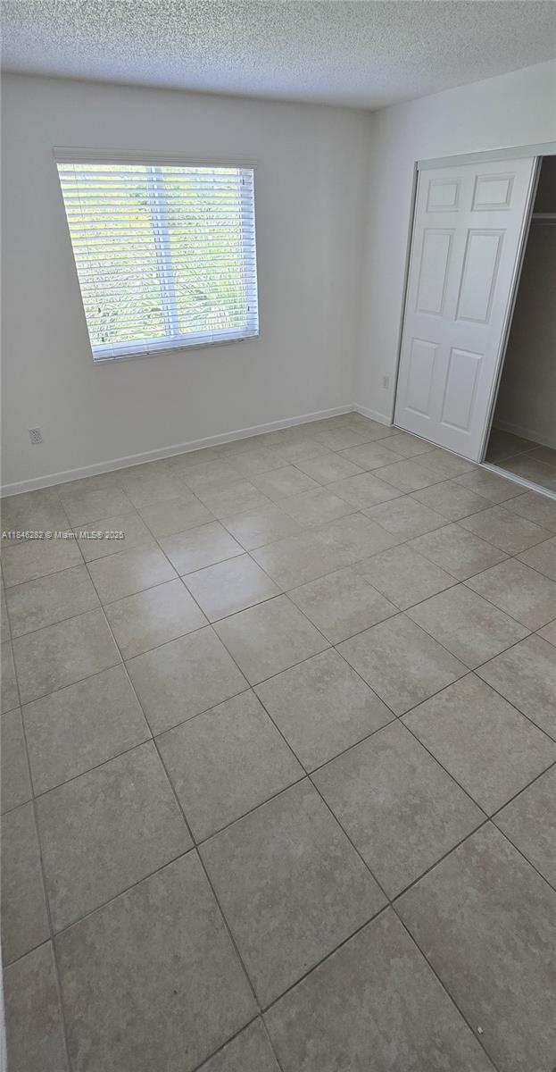 10820 Southwest 200th Drive, Unit 159 Cutler Bay, FL 33157 - Photo 9 of 17 a view of an empty room with a window