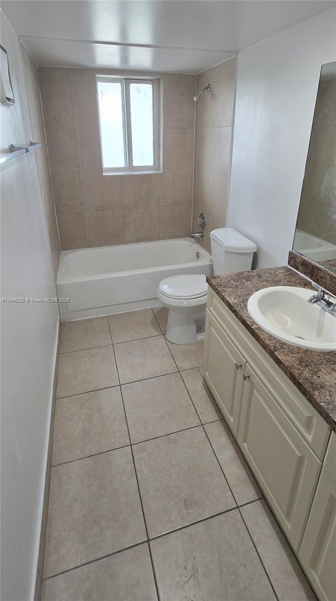 10820 Southwest 200th Drive, Unit 159 Cutler Bay, FL 33157 - Photo 10 of 17 a bathroom with a granite countertop sink a toilet a mirror and shower