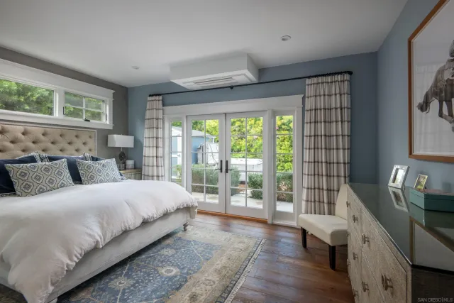 a bedroom with a large bed and a large window