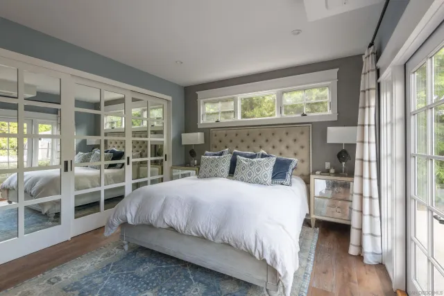 a bedroom with a bed and a large window