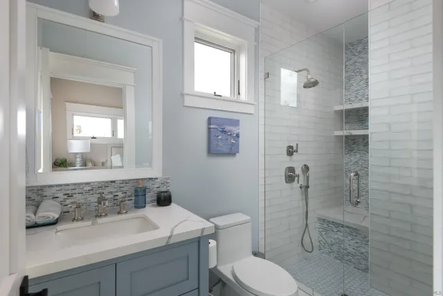 a bathroom with a sink toilet and shower