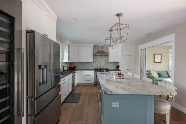 a kitchen with stainless steel appliances granite countertop a sink refrigerator and cabinets