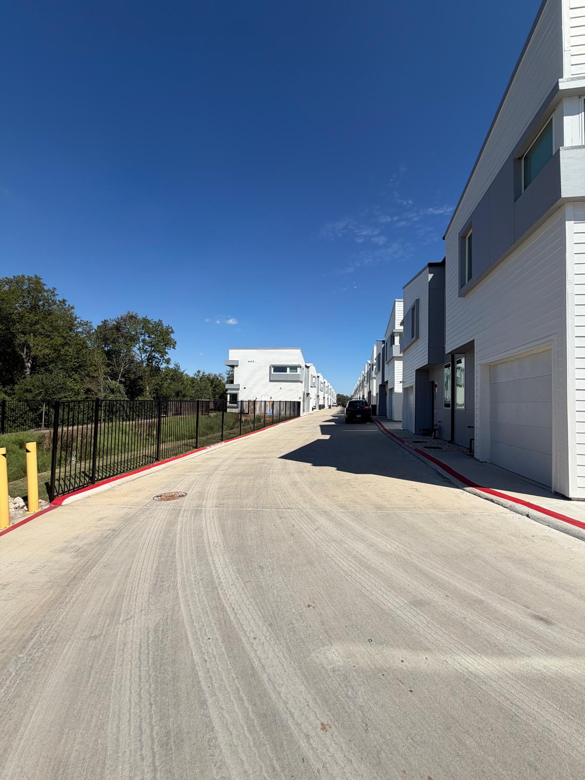 2000 Riverside Farms Road, Unit 12101 Austin, TX 78741 - Photo 3 of 33 Modern multi-level exterior architecture features clean lines under a bright blue sky.