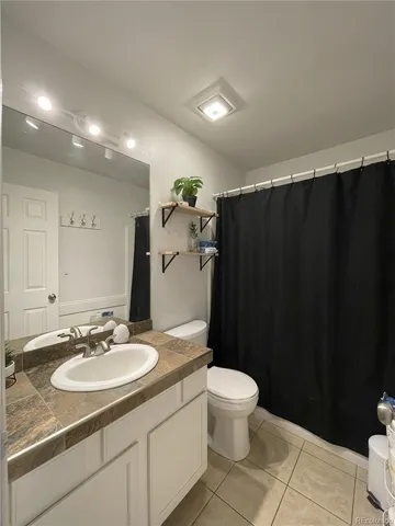 a bathroom with a sink a toilet a mirror and vanity