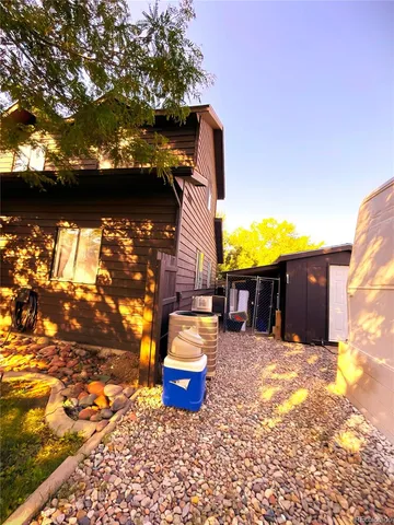 a view of a house with roof yard and sitting area