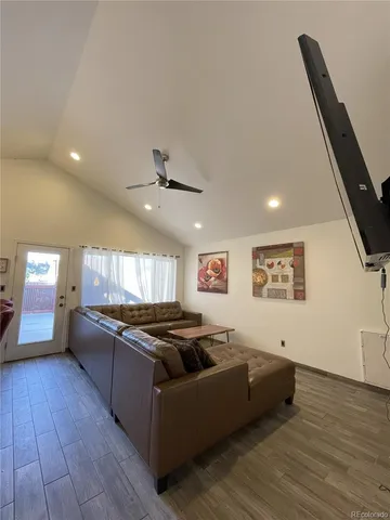 a large kitchen with stainless steel appliances granite countertop a lot of counter space and wooden floor