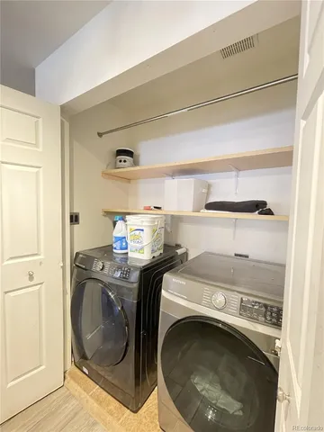 a utility room with sink dryer and washer