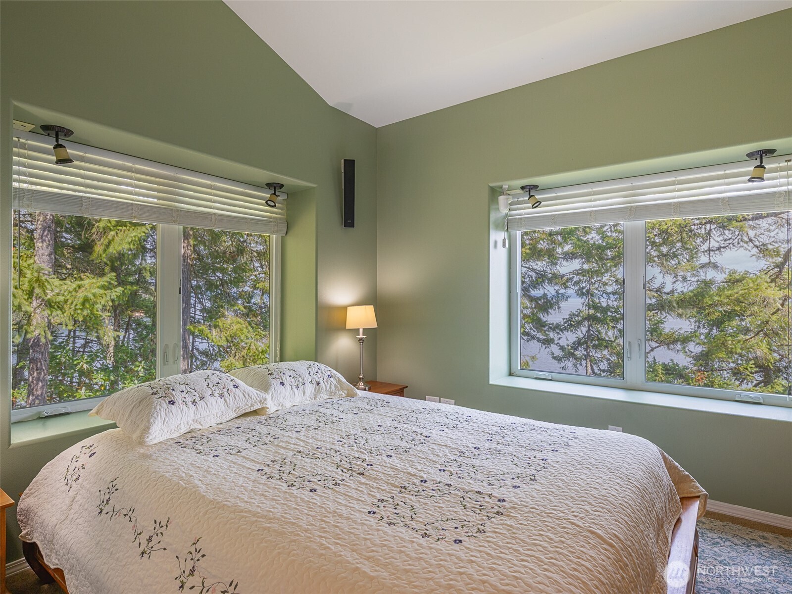 291 Pleasant Harbor Road Brinnon, WA 98320 - Photo 11 of 40 a bedroom with a large bed and a window