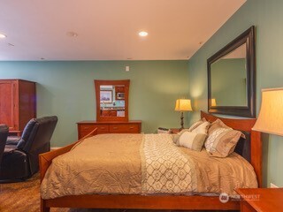 291 Pleasant Harbor Road Brinnon, WA 98320 - Photo 14 of 40 a bedroom with a bed and chair