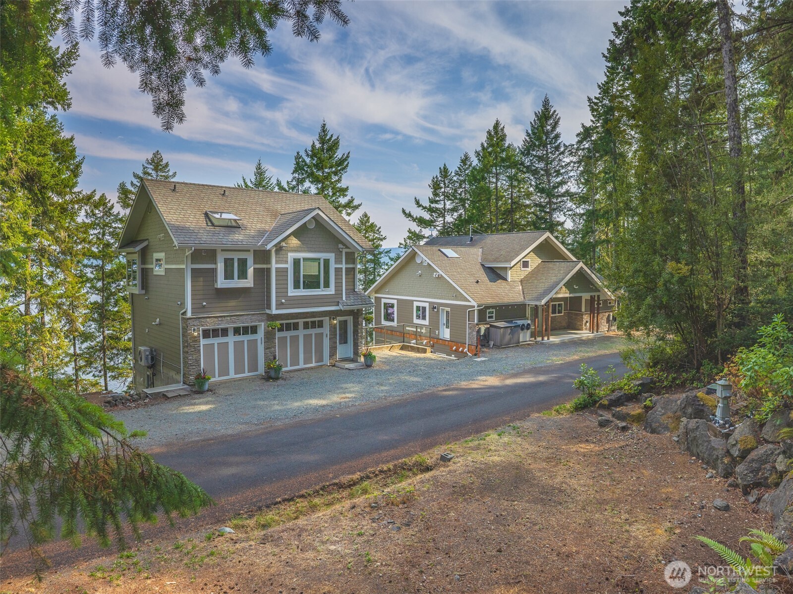 291 Pleasant Harbor Road Brinnon, WA 98320 - Photo 2 of 40 a front view of a house with a garden