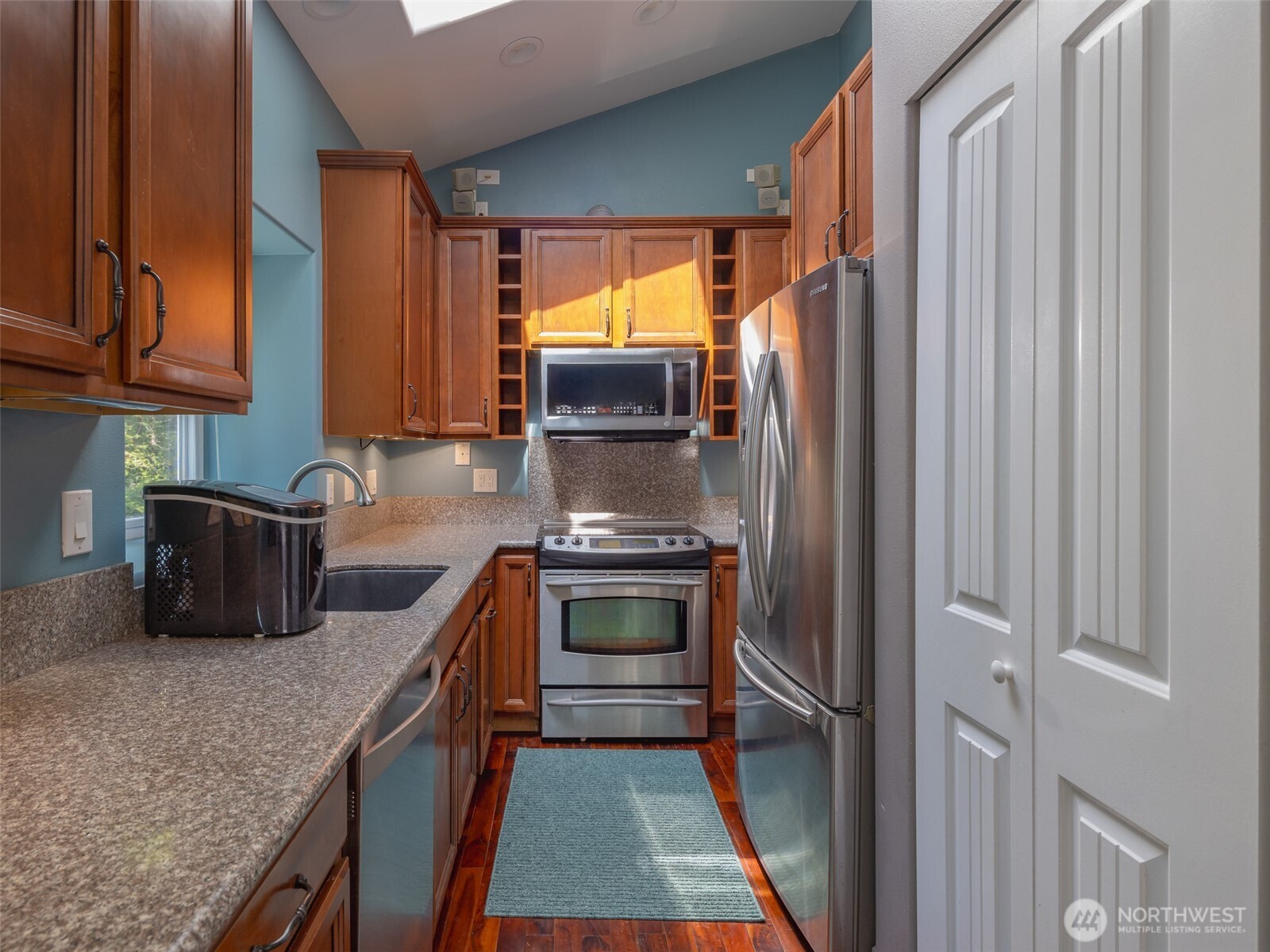 291 Pleasant Harbor Road Brinnon, WA 98320 - Photo 9 of 40 a kitchen with granite countertop a refrigerator stove and sink