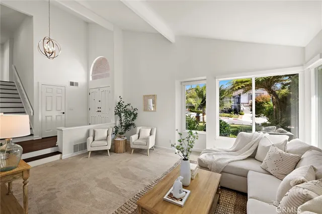 a living room with furniture and large windows