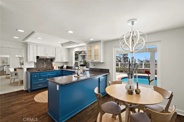 a kitchen with a dining table and chairs
