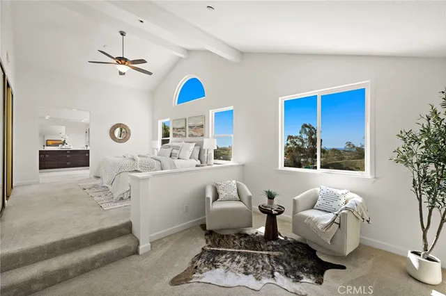 a bedroom with furniture and a large window