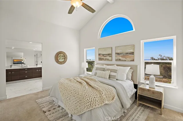 a bedroom with a bed and a view of kitchen