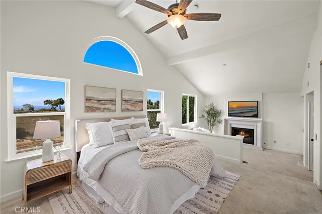 a bedroom with a bed a couch and a chandelier