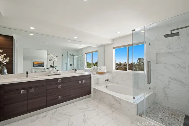 a large bathroom with a sink a large mirror and a bathtub