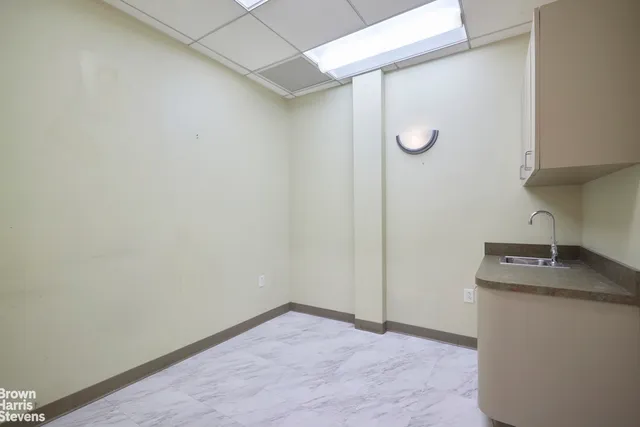a view of a hallway with wooden floor and closet