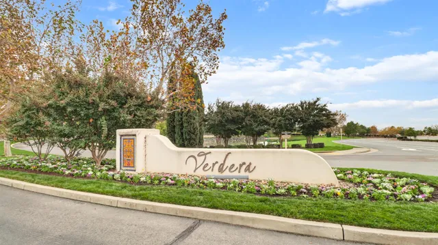 a view of a pathway with a wrought fence