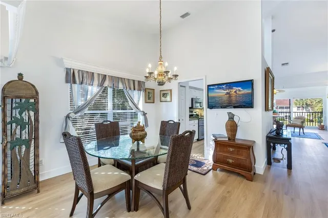 a dining room with furniture entryway and wooden floor