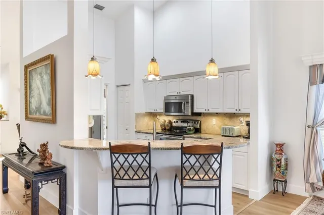 a kitchen with stainless steel appliances a stove a sink refrigerator and microwave