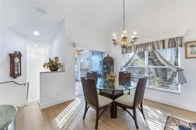a view of a dining room with furniture and chandelier