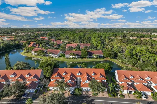 an aerial view of residential houses with outdoor space and ocean view