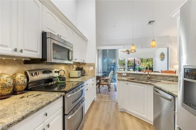 a kitchen with a sink stove top oven and microwave