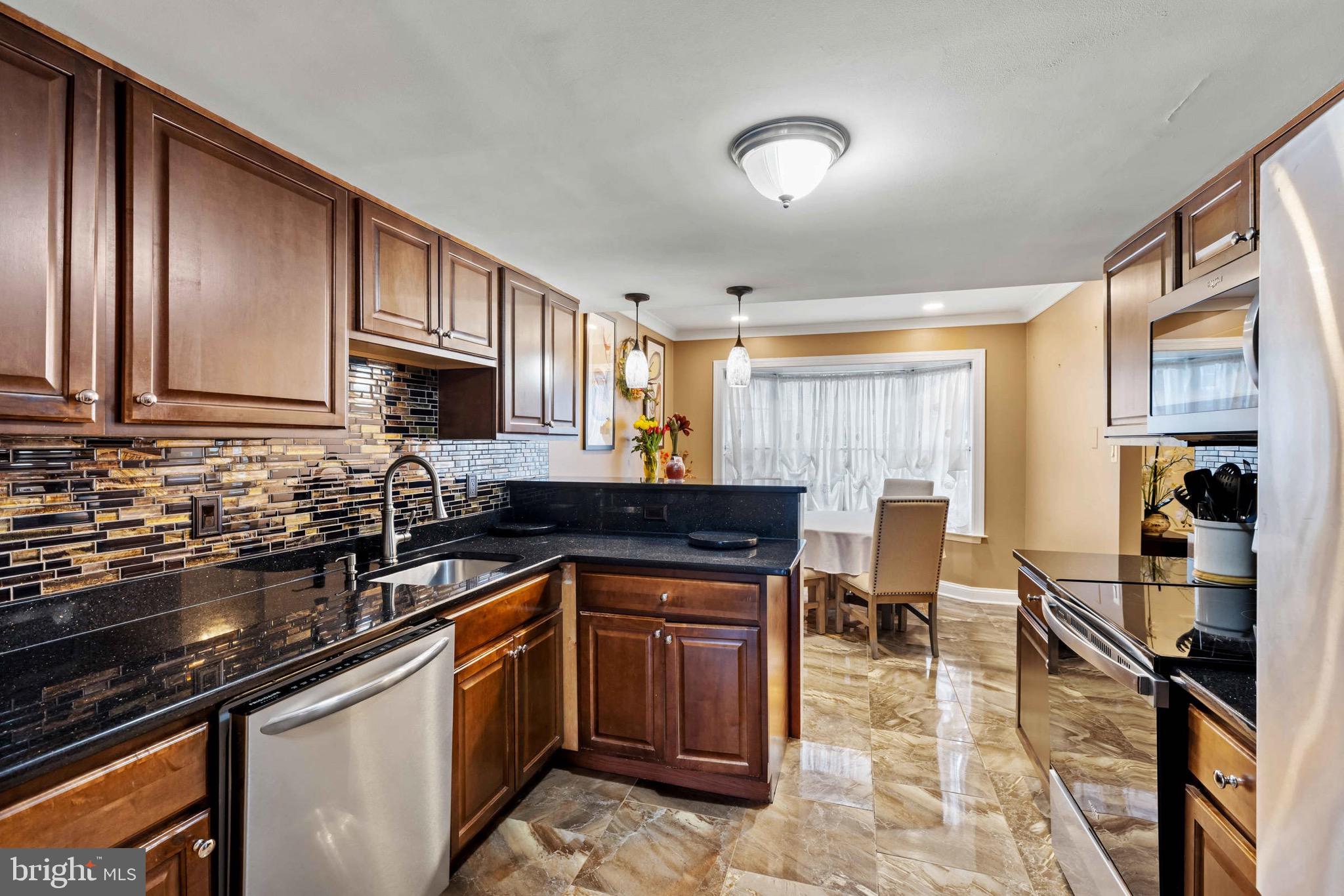 8610 Kelso Terrace Gaithersburg, MD 20877 - Photo 6 of 33 a kitchen with a sink stove and cabinets