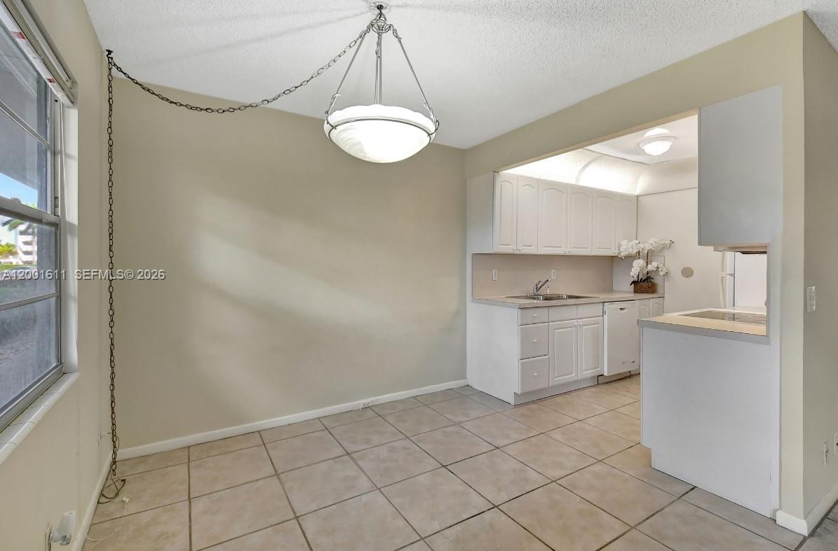 1020 Exeter, Unit 1020 Boca Raton, FL 33434 - Photo 14 of 15 a kitchen with a sink cabinets and window