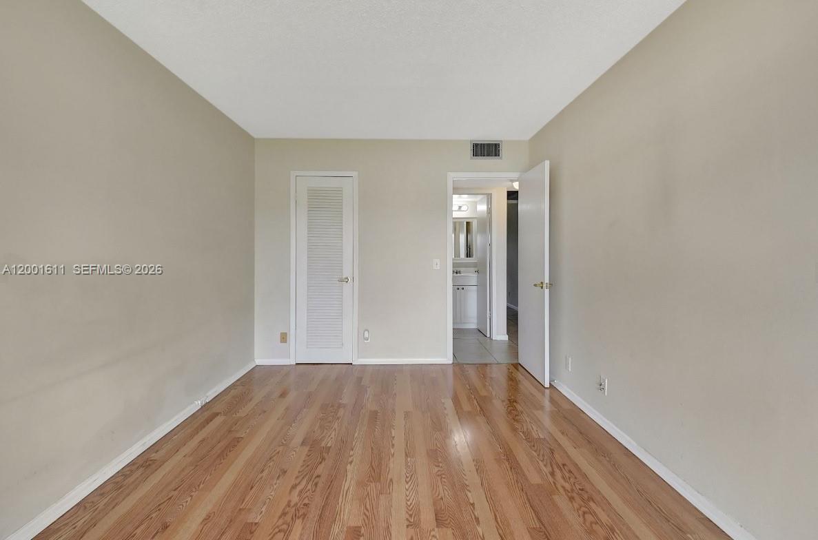 1020 Exeter, Unit 1020 Boca Raton, FL 33434 - Photo 2 of 15 a view of a room with wooden floor