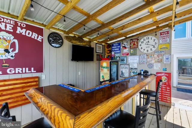 a outdoor living space with furniture and a flat screen tv