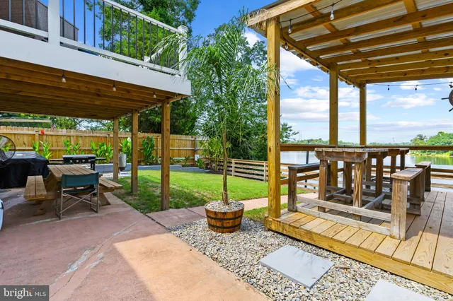 a view of a patio with a table chairs and a backyard
