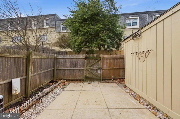 a view of a pathway gate with wooden fence
