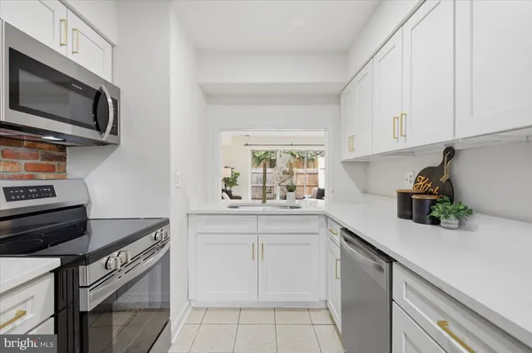 a kitchen with a sink and white cabinets