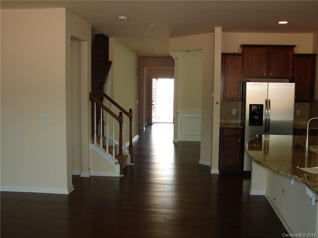 4316 Perth Road, Unit 290 Indian Land, SC 29707 - Photo 2 of 11 a hallway with wooden floor table and chairs