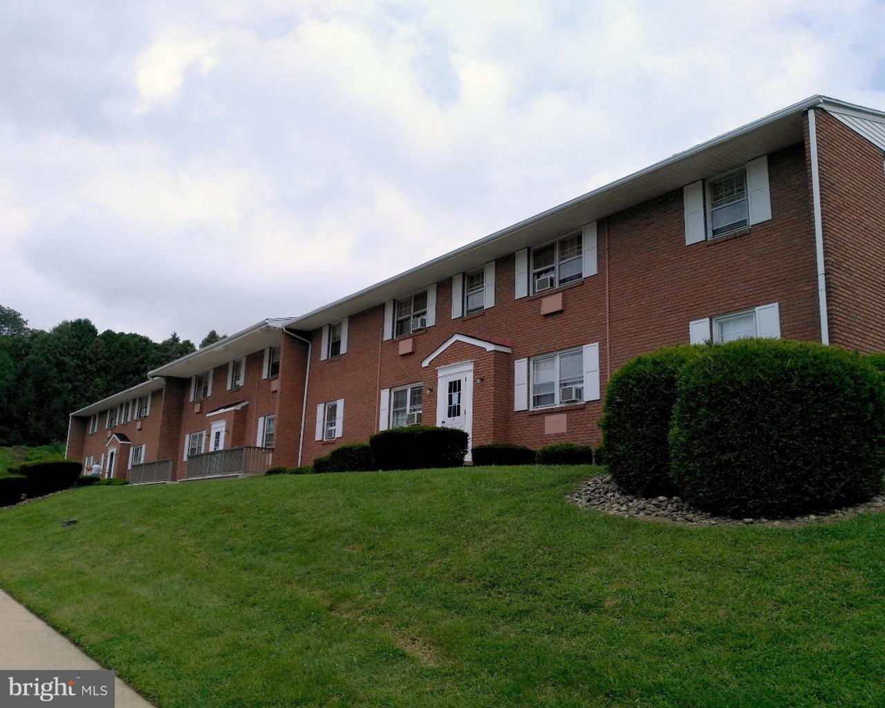 6 Orchard Hills Drive, Unit B Boyertown, PA 19512 - Photo 1 of 8 a front view of a house with a garden