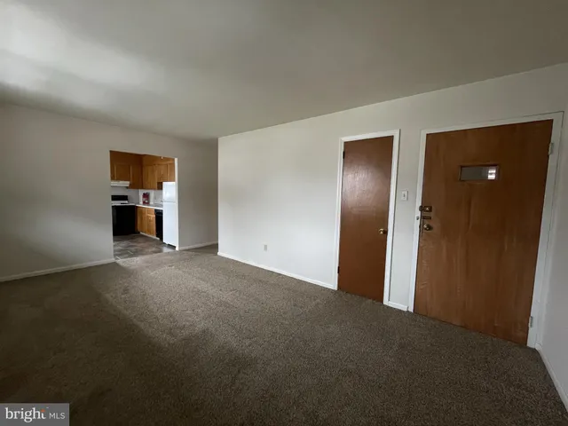 a view of empty room with furniture and wooden floor