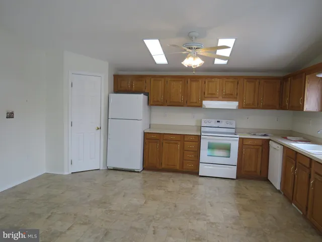 a kitchen with a stove a sink and a refrigerator
