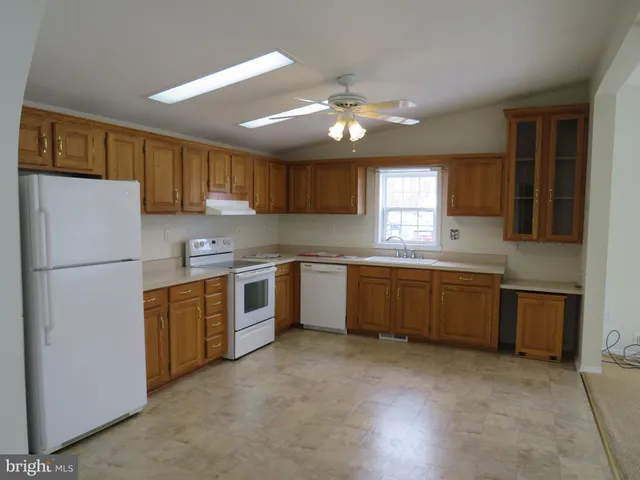 a kitchen with a refrigerator sink and cabinets