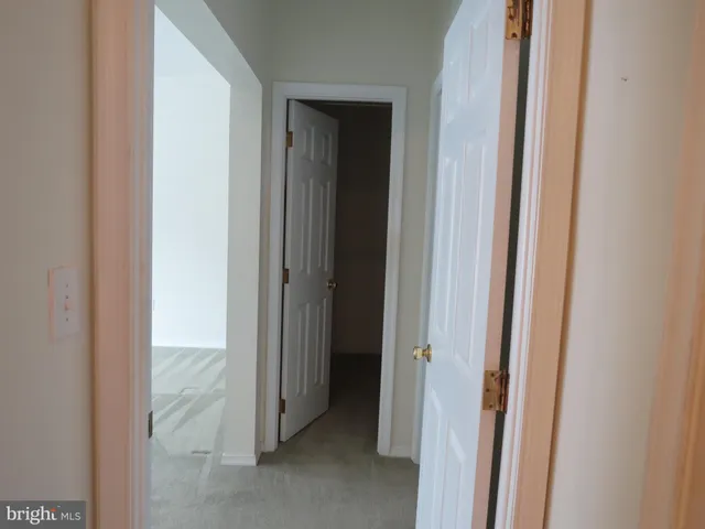 a view of a bathroom from a hallway