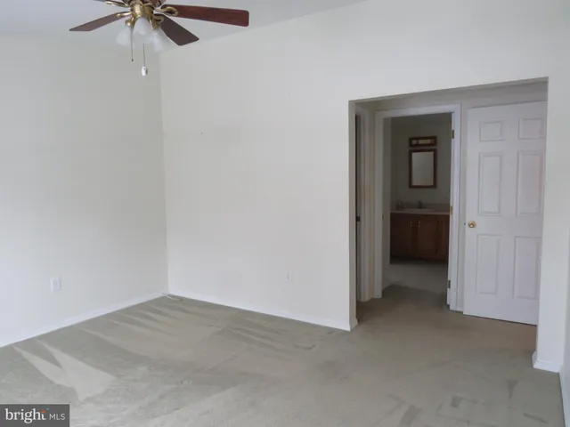a view of a room with a ceiling fan