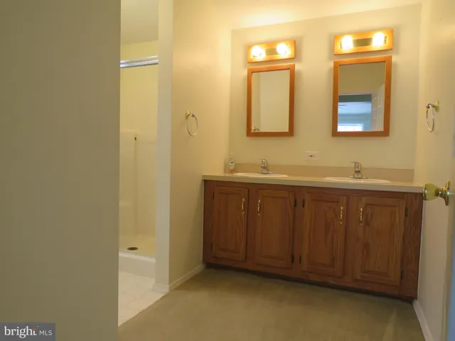 a bathroom with a double vanity sink and a mirror