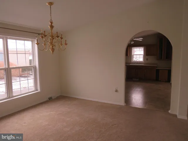 a view of entryway with window and chandelier fan