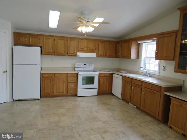a kitchen with a sink cabinets and window