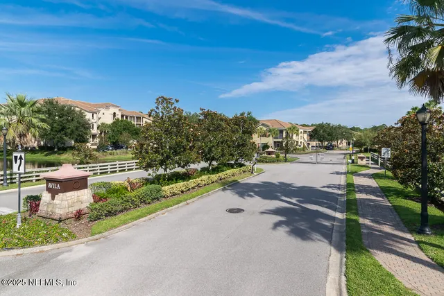 a view of a street with a yard